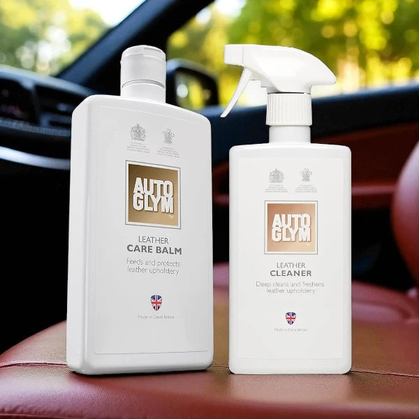 Two AutoGlym leather care products on a car seat with a blurred car interior background.